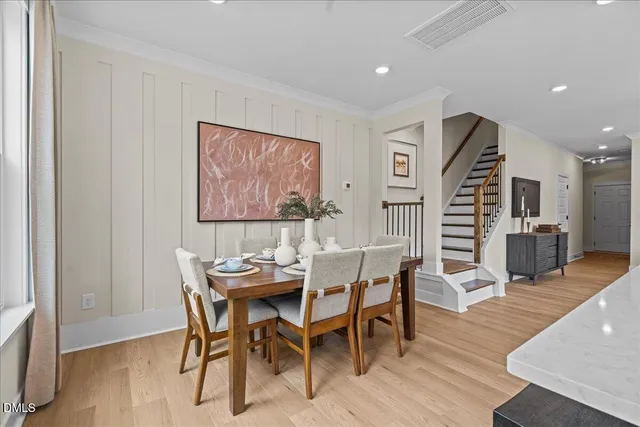 a dining room with furniture and wooden floor