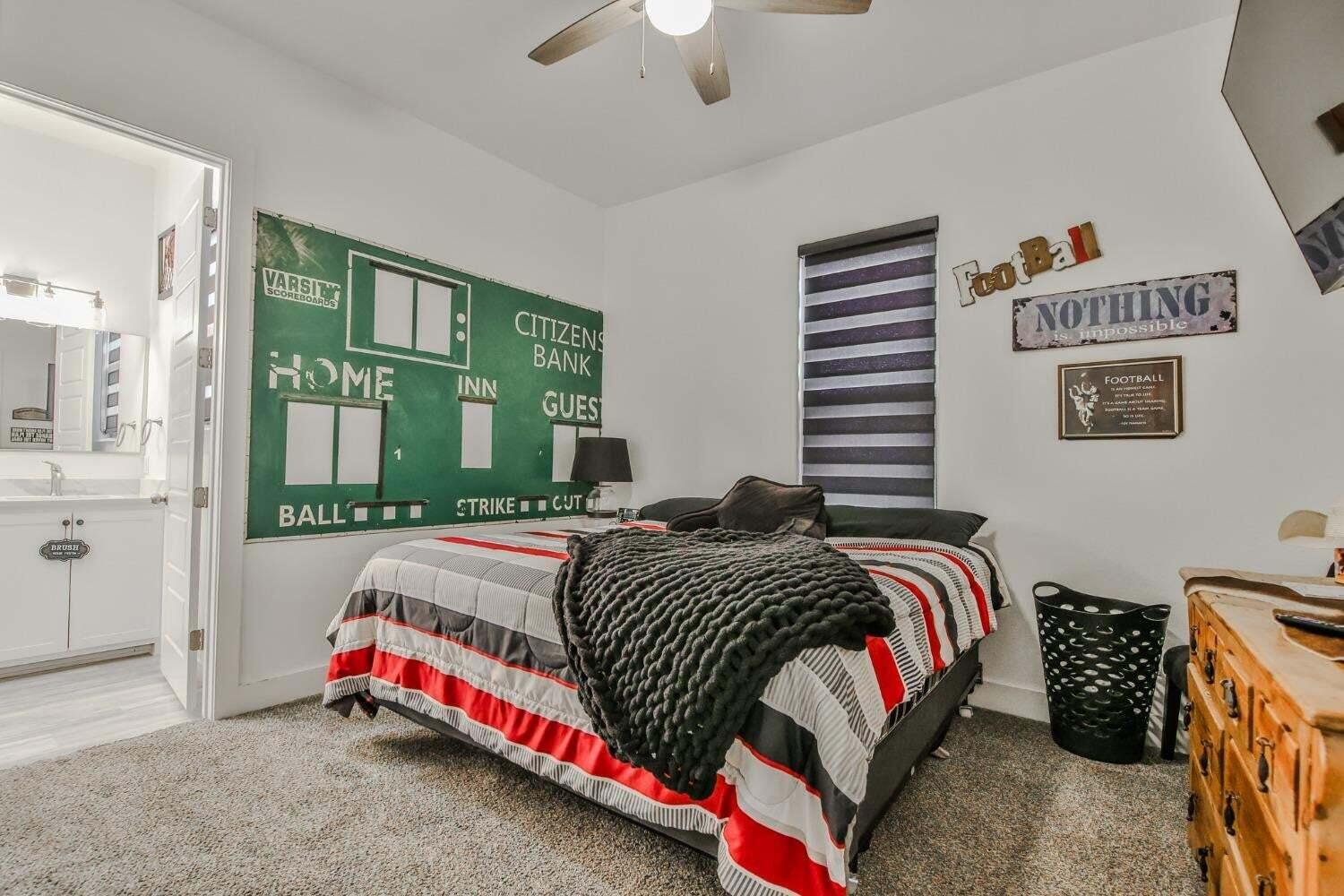 19210 County Road 2240 Lubbock, TX 79423 - Photo 21 of 46 a bedroom with a bed and a chandelier
