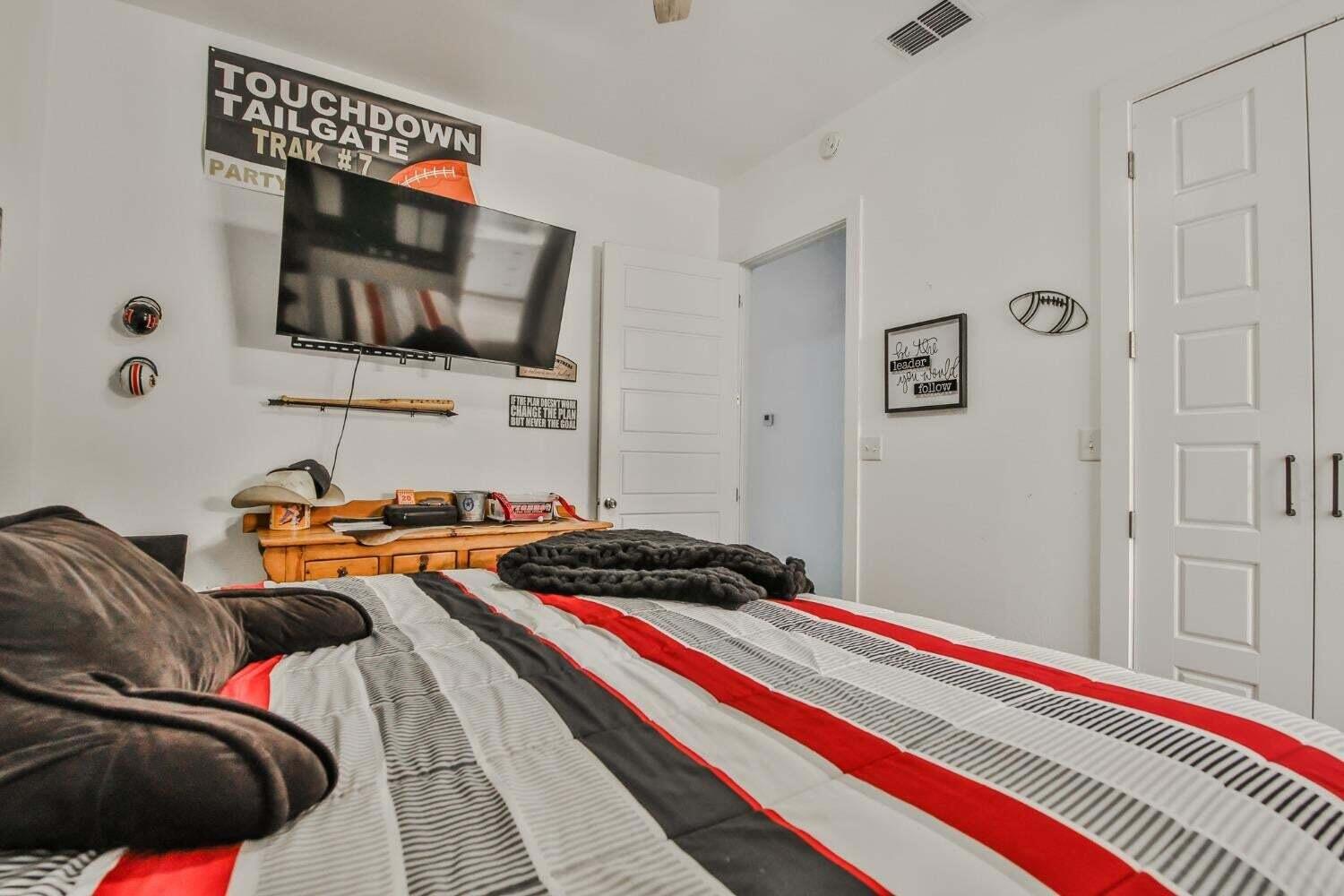 19210 County Road 2240 Lubbock, TX 79423 - Photo 22 of 46 a bedroom with a bed and a flat screen tv
