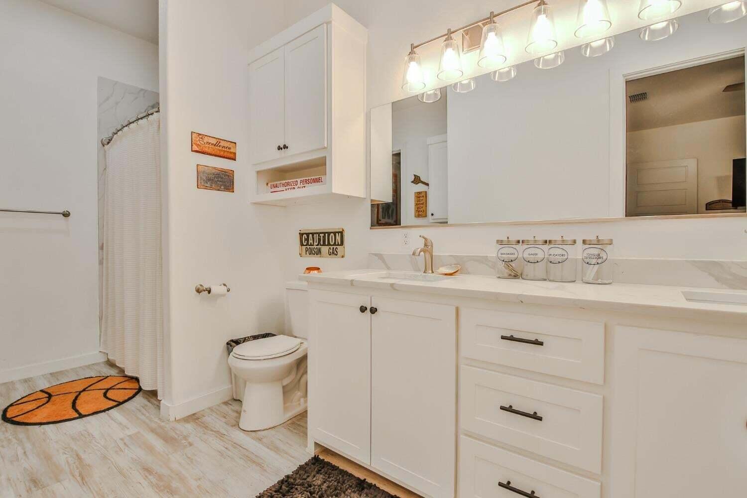 19210 County Road 2240 Lubbock, TX 79423 - Photo 24 of 46 a bathroom with a sink and a mirror