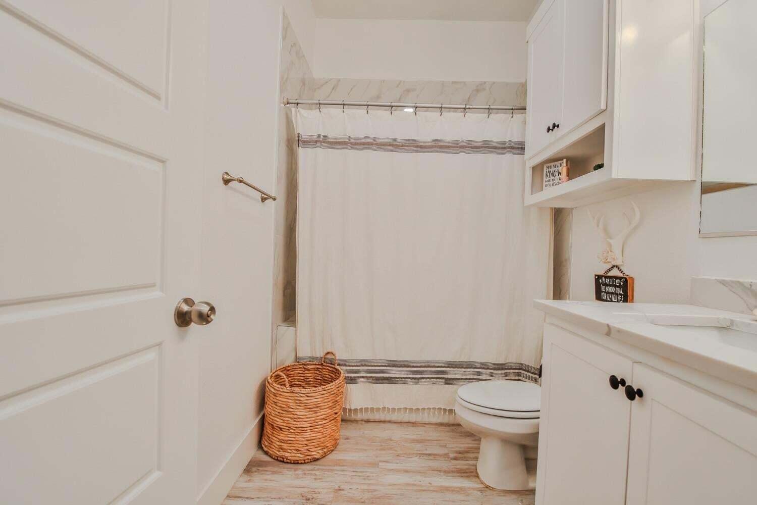 19210 County Road 2240 Lubbock, TX 79423 - Photo 33 of 46 a bathroom with a granite countertop sink toilet and shower