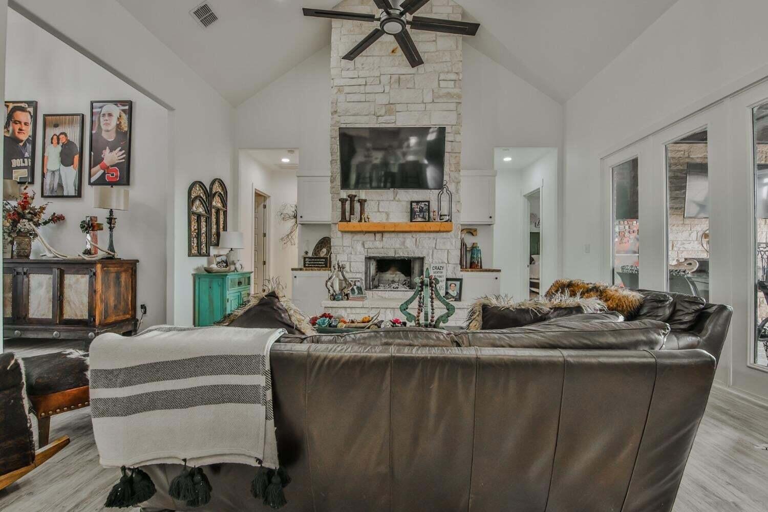 19210 County Road 2240 Lubbock, TX 79423 - Photo 5 of 46 a dining room with furniture and a fireplace