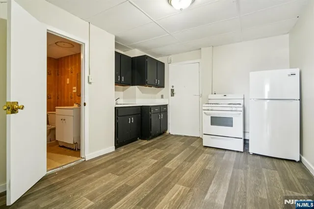 a kitchen with stainless steel appliances a refrigerator and a stove top oven