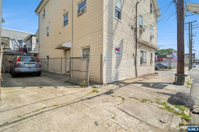 a view of a car park in front of a house