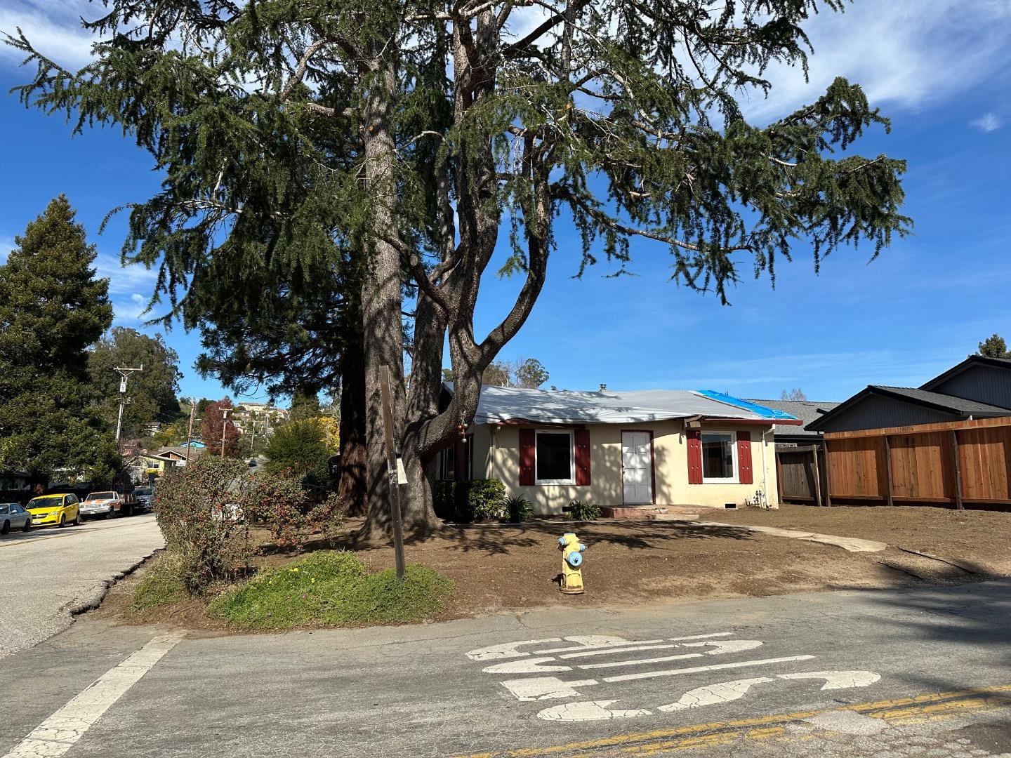 2505 Howe Street Santa Cruz, CA 95065 - Photo 7 of 14 a front view of a house with a yard garage and outdoor seating