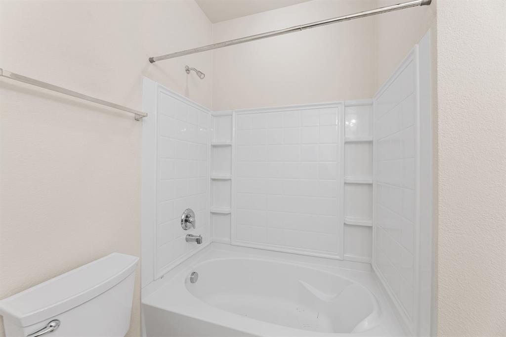 719 Scenic Ranch Circle Fairview, TX 75069 - Photo 31 of 36 a white bath tub sitting next to a white toilet and vanity