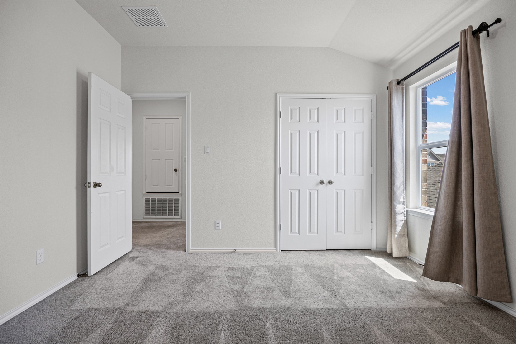 2471 Sunrise Road, Unit 64 Round Rock, TX 78664 - Photo 26 of 32 A well-lit bedroom provides ample space and cozy carpeting, perfect for quiet relaxation.
