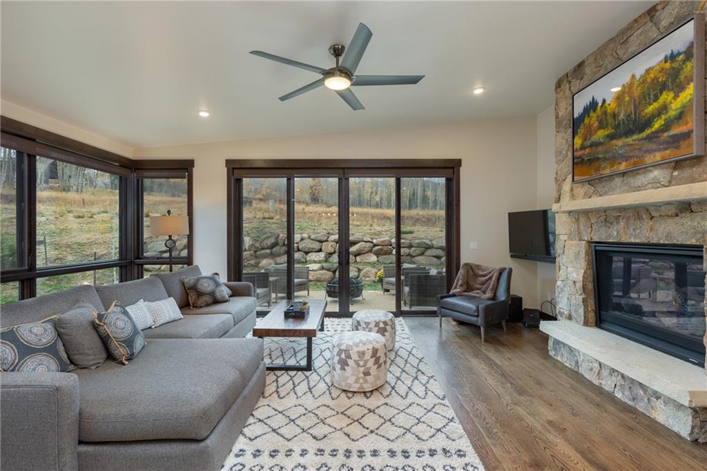 137 Moss Way Silverthorne, CO 80498 - Photo 11 of 25 a living room with furniture large windows and a fireplace