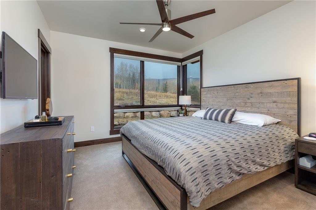 137 Moss Way Silverthorne, CO 80498 - Photo 14 of 25 a large bed sitting in a bedroom next to a window