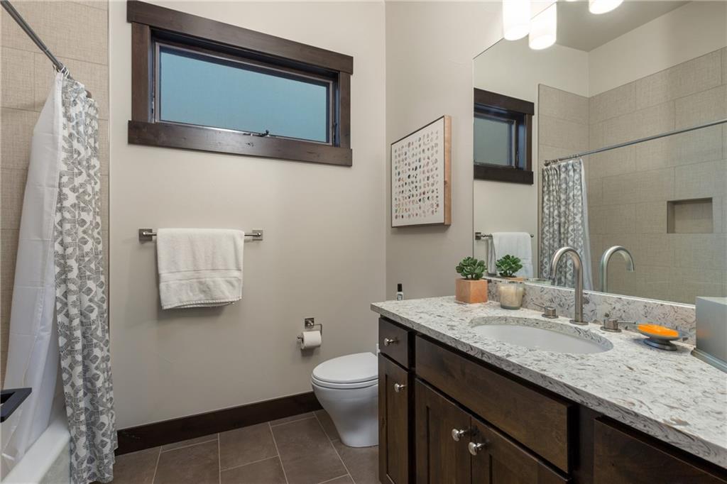 137 Moss Way Silverthorne, CO 80498 - Photo 18 of 25 a bathroom with a granite countertop toilet sink and mirror