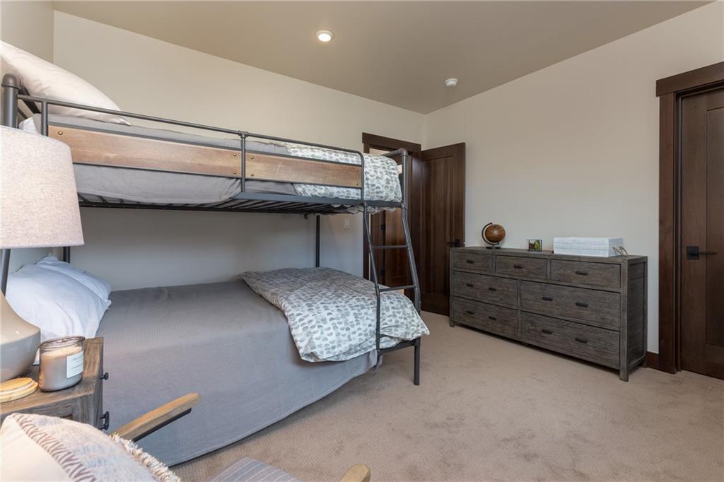 137 Moss Way Silverthorne, CO 80498 - Photo 19 of 25 a bedroom with a bed and a dresser