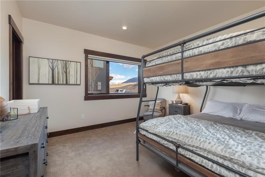 137 Moss Way Silverthorne, CO 80498 - Photo 20 of 25 a bedroom with a bed window and dresser