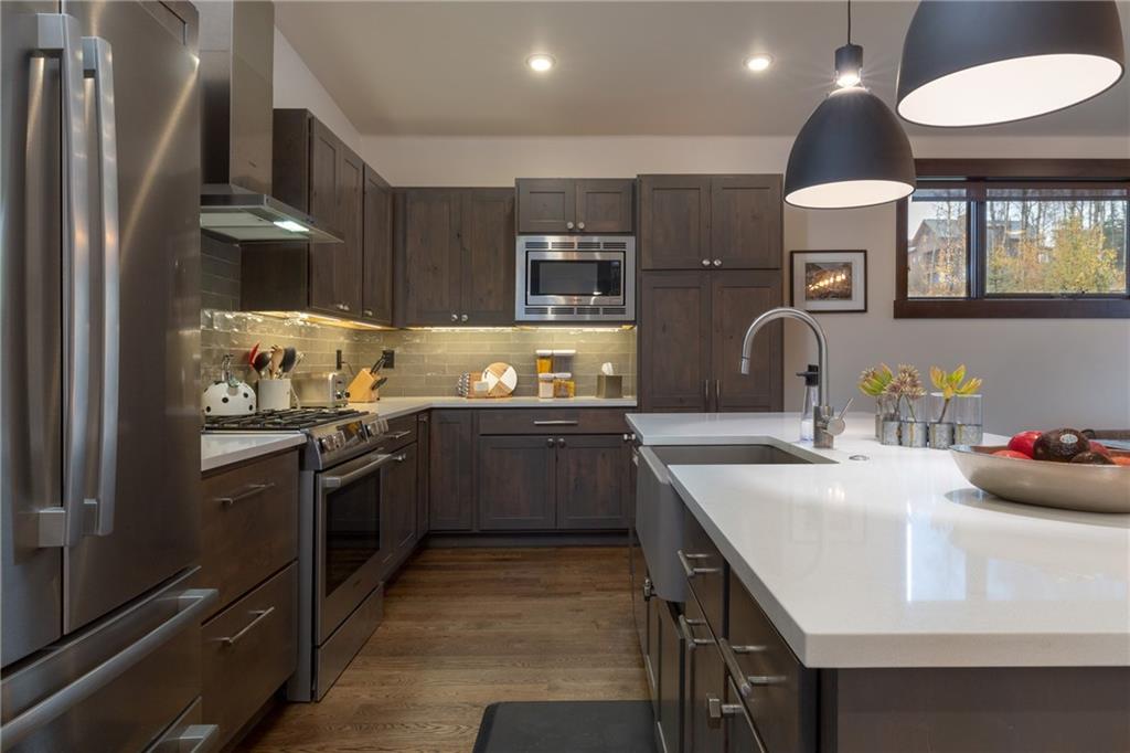 137 Moss Way Silverthorne, CO 80498 - Photo 6 of 25 a kitchen with stainless steel appliances a sink stove and refrigerator