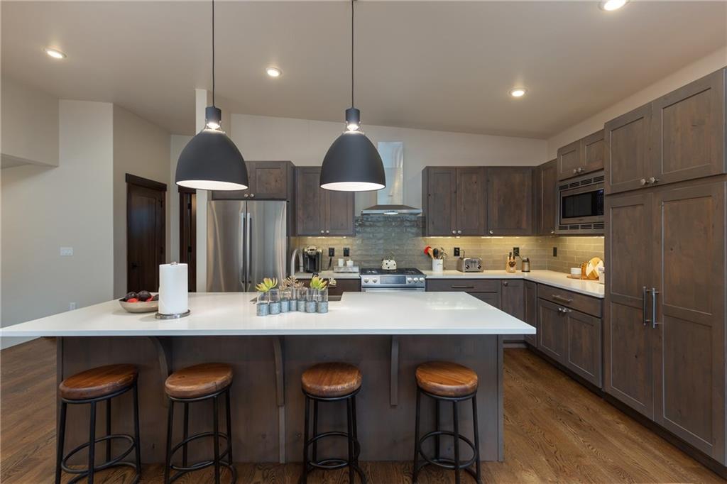 137 Moss Way Silverthorne, CO 80498 - Photo 7 of 25 a kitchen with stainless steel appliances granite countertop a sink a stove and a refrigerator
