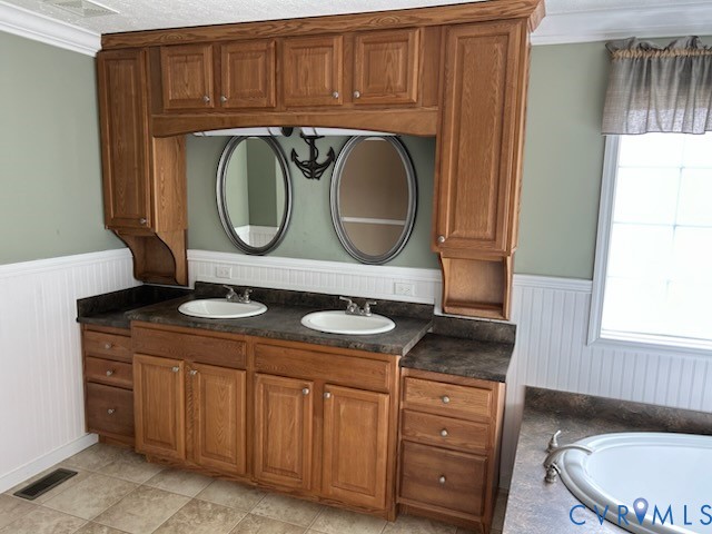 15910 Nobles Road Disputanta, VA 23842 - Photo 28 of 38 Bathroom featuring crown molding, double vanity, a