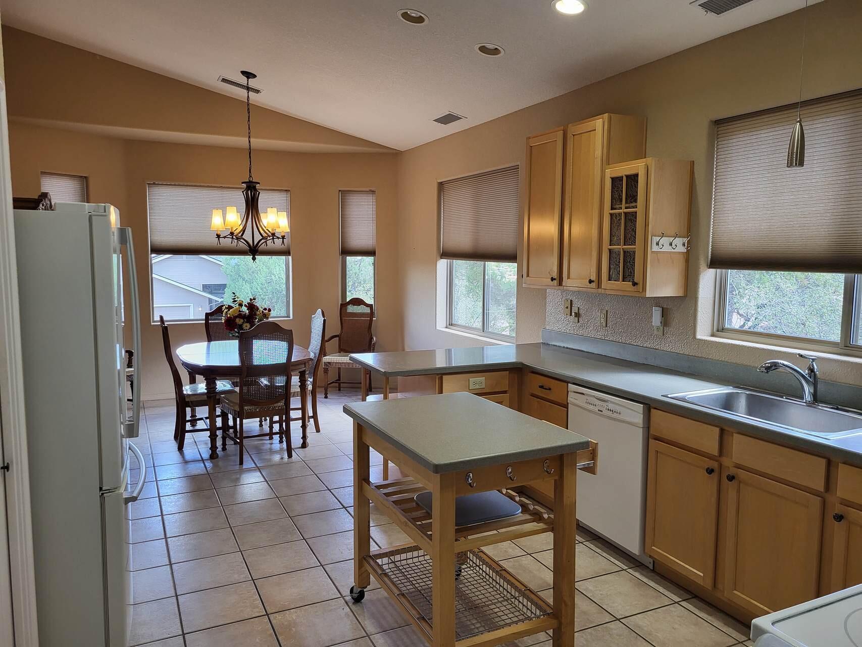 1120 South Sycamore Circle Payson, AZ 85541 - Photo 7 of 44 a dining hall with stainless steel appliances granite countertop a sink a stove a dining table and chairs