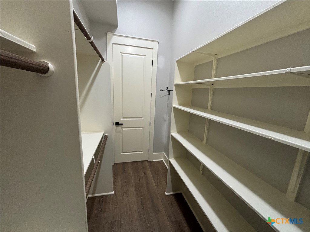 110 Hiram Cook Blanco, TX 78606 - Photo 43 of 46 a view of walk in closet with wooden floor