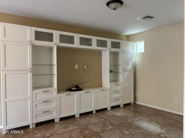a room with cabinets and gym equipment