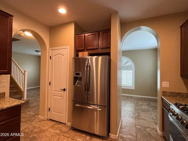 a view of kitchen with stainless steel appliances granite countertop a refrigerator and a sink