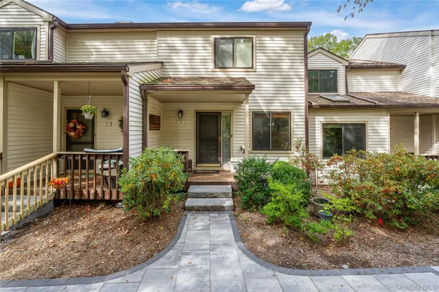 a view of a brick house with potted plants