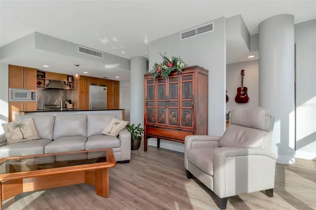 a kitchen with stainless steel appliances granite countertop a sink a stove and a wooden floors