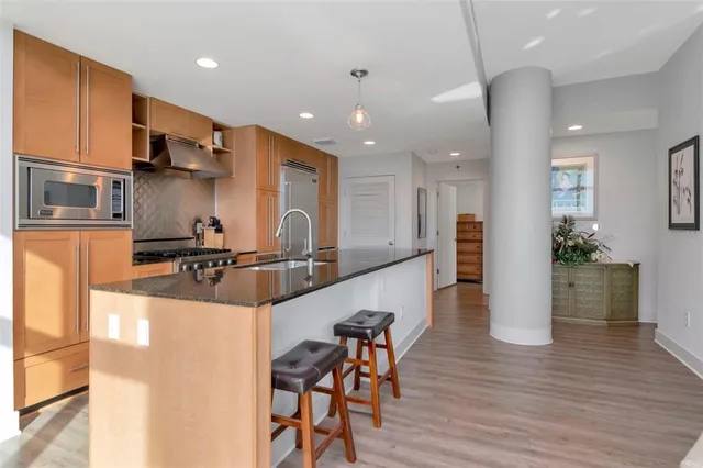 a kitchen with stainless steel appliances granite countertop a sink and a stove