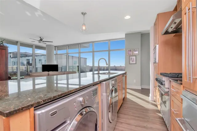 a bedroom with a bed a mirror on the dresser and a window