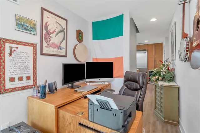 a roof deck with table and chairs a barbeque with wooden floor