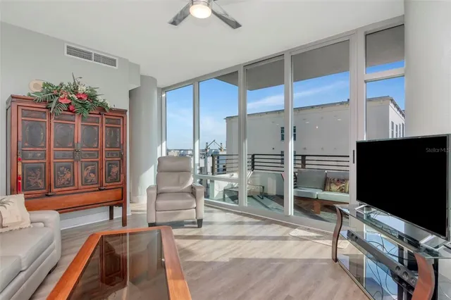 a living room with furniture and a potted plant