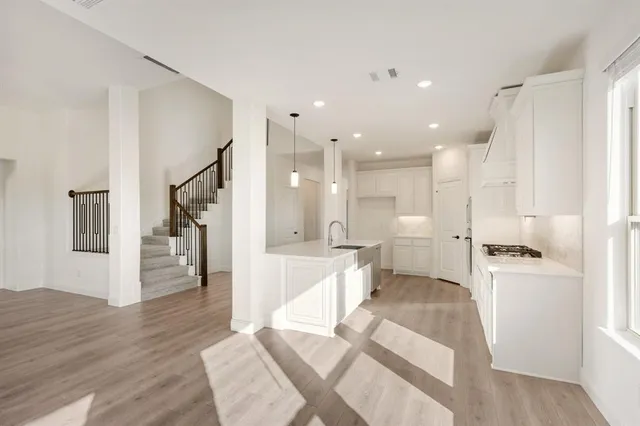 a large white kitchen with a large window