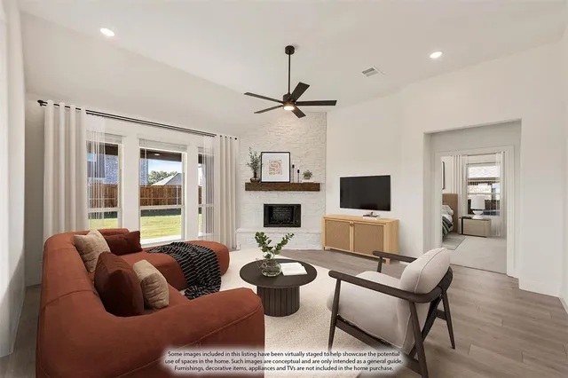 a living room with furniture a flat screen tv and a large window