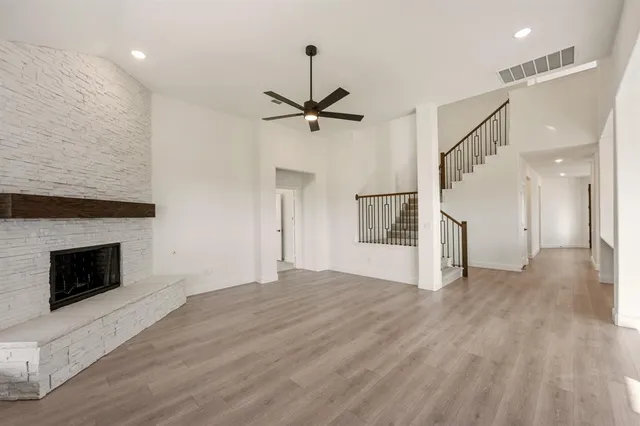 a view of an empty room with a fireplace