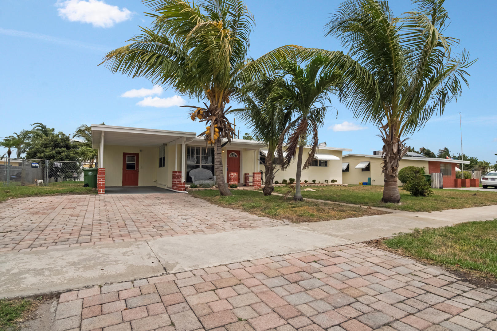320 East Lake Road Palm Springs, FL 33461 - Photo 1 of 22 a view of a house with a yard and coconut trees