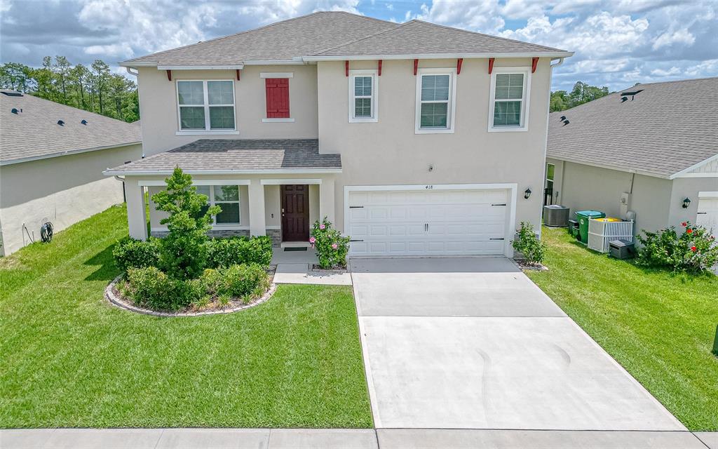 418 Anne Street Deland, FL 32724 - Photo 1 of 49 a front view of a house with a yard