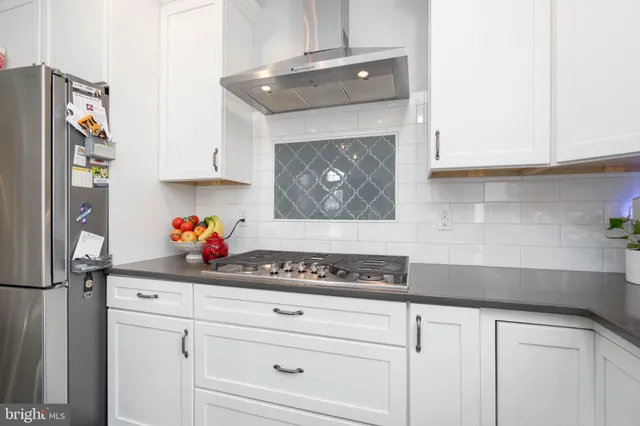 a living room with furniture and a hard wood floor