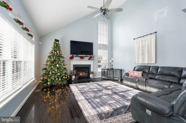 a living room with furniture stairs and a potted plant