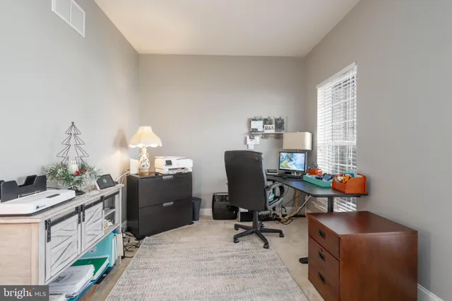 a bathroom with a sink vanity mirror and toilet