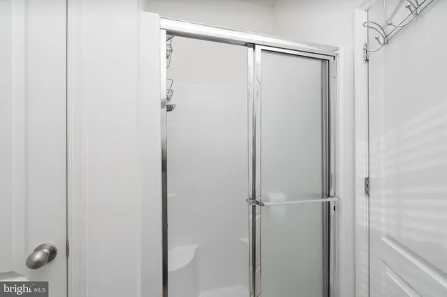 a bedroom with bed and a flat tv screen on dresser