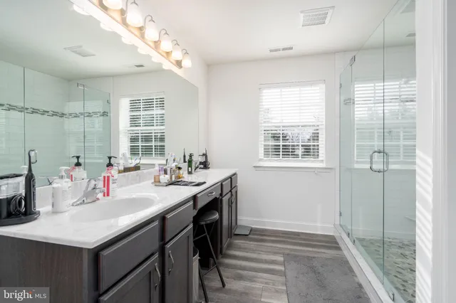 a bedroom with a bed and a flat tv screen on dresser