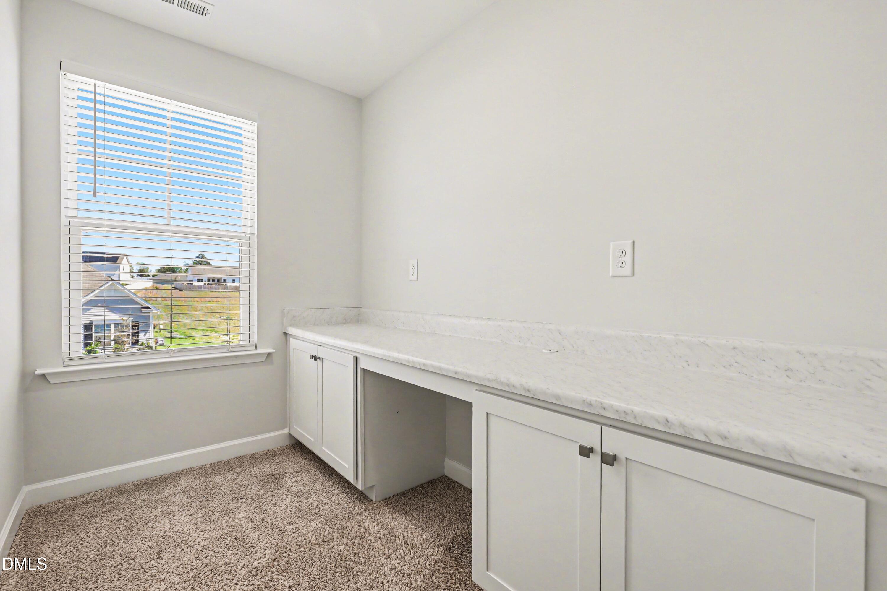 90 Rigsby Avenue Four Oaks, NC 27524 - Photo 23 of 43 a view of storage and utility room with window