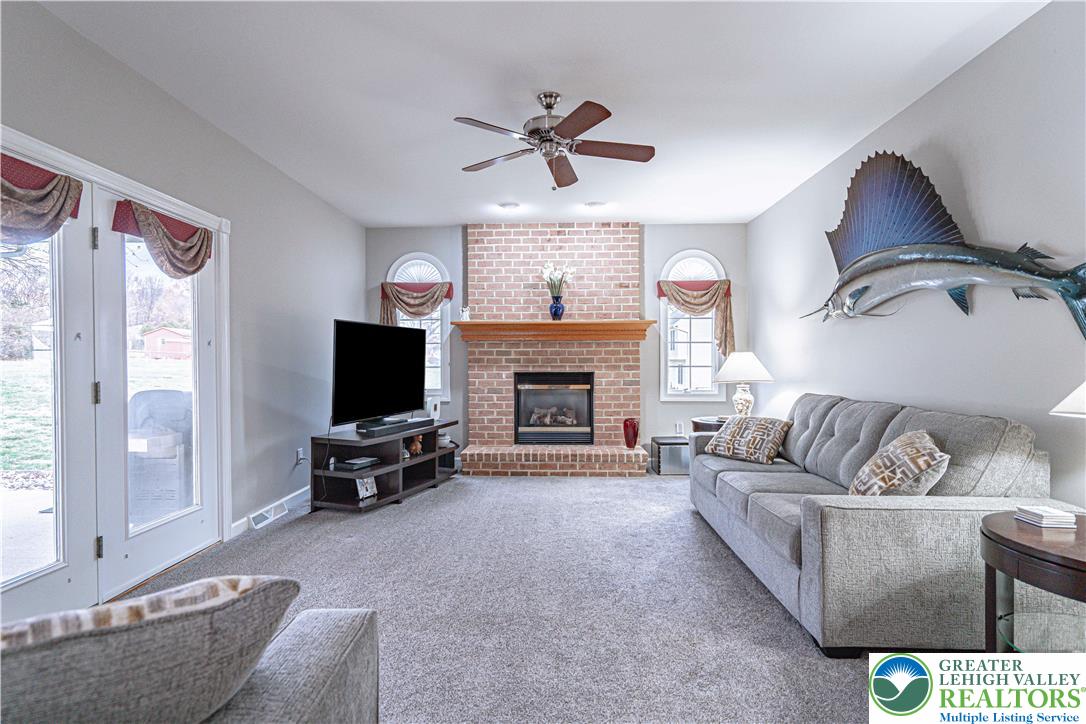 6551 Overlook Road Orefield, PA 18069 - Photo 31 of 82 a living room with furniture a flat screen tv and a fireplace