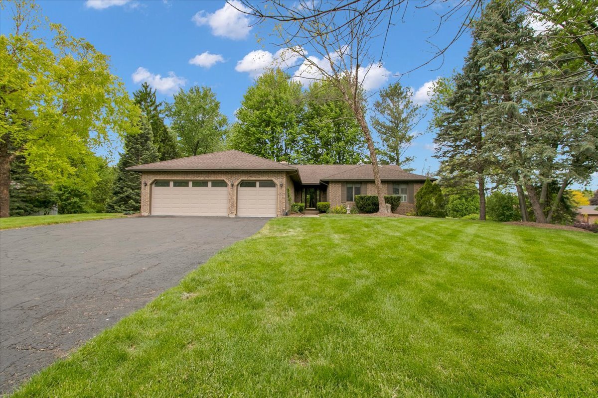 a front view of house with yard and green space