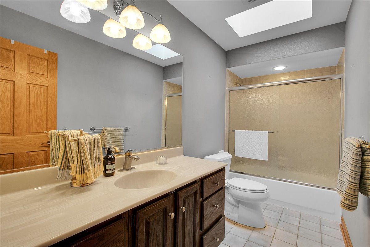 90 Briargate Road Cary, IL 60013 - Photo 22 of 42 a bathroom with a sink a toilet and a mirror
