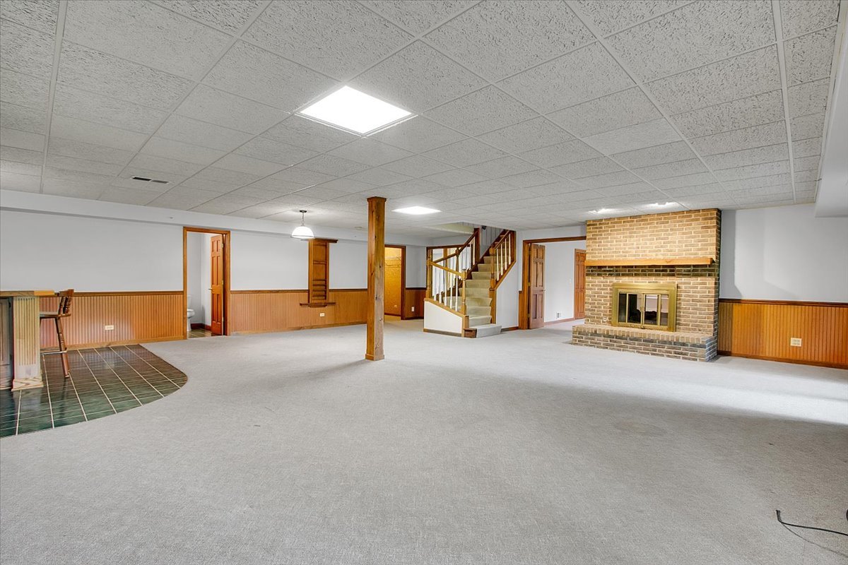 90 Briargate Road Cary, IL 60013 - Photo 25 of 42 a view of a hallway with a couch and a fireplace