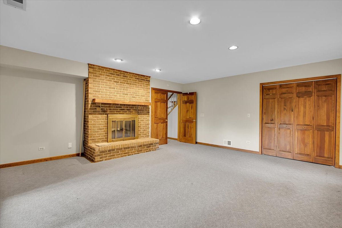 90 Briargate Road Cary, IL 60013 - Photo 29 of 42 a view of an empty room with a fireplace and a window