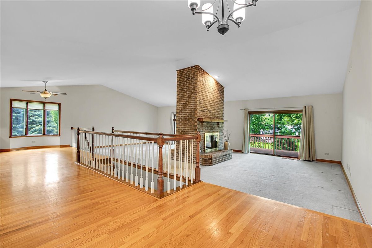 90 Briargate Road Cary, IL 60013 - Photo 3 of 42 a view of a room with wooden floor potted plant and windows