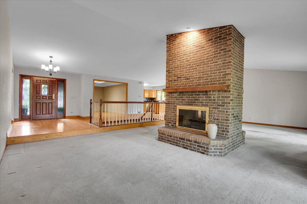 90 Briargate Road Cary, IL 60013 - Photo 4 of 42 a view of empty room with fireplace and fan