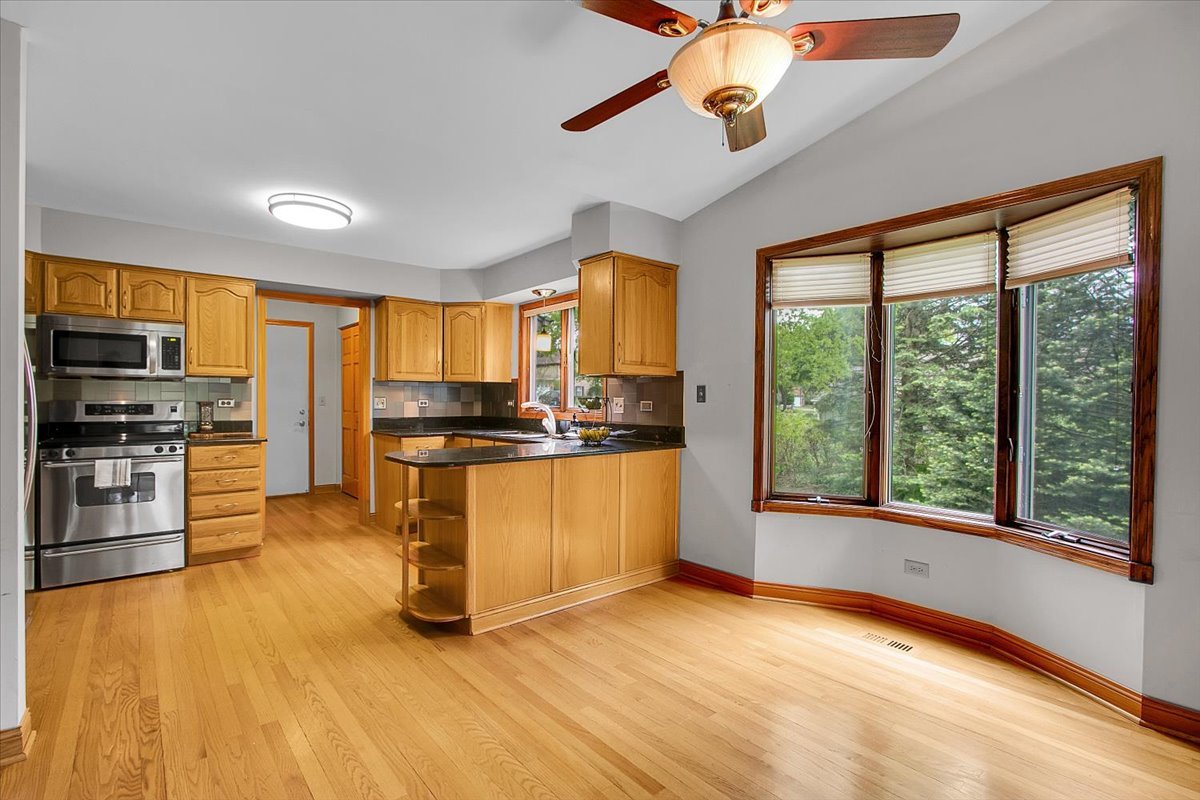 90 Briargate Road Cary, IL 60013 - Photo 8 of 42 a kitchen with stainless steel appliances granite countertop a stove a sink and a refrigerator