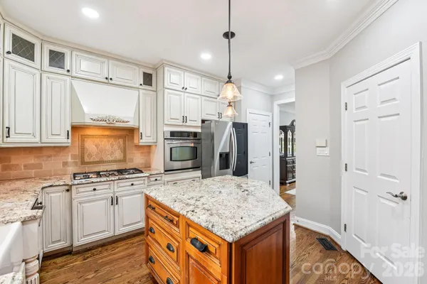 a kitchen with a stove a refrigerator and a sink