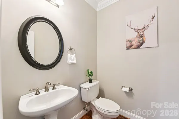a bathroom with a toilet a sink and a mirror